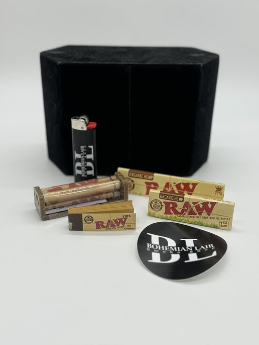 Nice Raw starter pack includes a Raw Roller, Raw Tips, Raw 1.25 and Kingsize Slim Papers, along with a Bohemian Lair Bic Lighter and a sticker from Bohemian Lair.